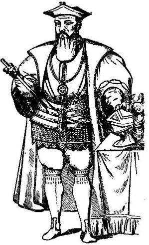 Black-and-white illustration of Vasco da Gama standing in a hat and decorated coat, holding a staff beside a helmet on a draped table.